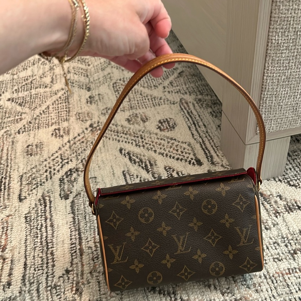 Small handle authentic Louis Vuitton bag with red velvet lining